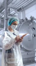 An inspector checking GMP compliance of AdvaCare Pharma pharmaceutical manufacturing facility. An inspector checking GMP compliance of AdvaCare Pharma pharmaceutical manufacturing facility.