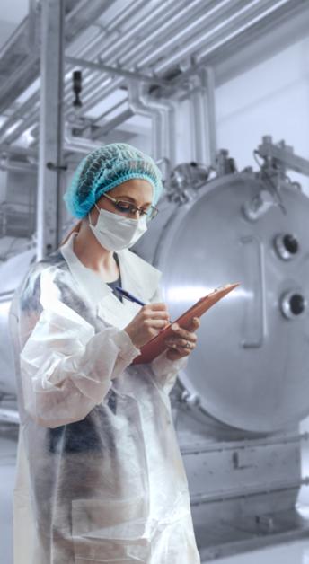 An inspector checking GMP compliance of AdvaCare Pharma pharmaceutical manufacturing facility. An inspector checking GMP compliance of AdvaCare Pharma pharmaceutical manufacturing facility.
